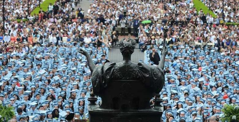 Graduates sitting in blue