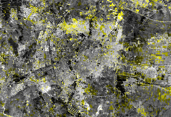 Satellite image captured by the Landsat 8 satellite on June 11, 2016. Highlighted in yellow are areas where this image is much darker or lighter than it was in the Landsat satellite image taken two weeks earlier. This experimental analysis can help reveal where damage has occurred in the city. Yellow marks on a black and white map highlight areas of damage