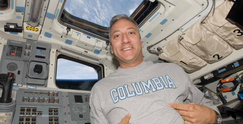 Photo Courtesy of NASA Mike Massimino in a space shuttle