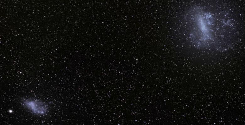In a new study, astronomers show how gas expelled in the merger of two small galaxies can linger across vast distances for billions of years, where it may eventually feed gas to more massive galaxies to make new stars. The Large Magellanic Cloud and the Small Magellanic Cloud pictured above are a pair of dwarf galaxies that were in the process of merging when they fell into the Milky Way. Their gas is expected to replenish half of the gas consumed by our galaxy as it forms new stars. (Photo: S. Brunier/European Southern Observatory) In a new study, astronomers show how gas expelled in the merger of two small galaxies can linger across vast distances for billions of years, where it may eventually feed gas to more massive galaxies to make new stars. The Large Magellanic Cloud and the Small Magellanic Cloud pictured above are a pair of dwarf galaxies that were in the process of merging when they fell into the Milky Way. Their gas is expected to replenish half of the gas consumed by our galaxy as it forms new stars. (Photo: S. Brunier/Euro