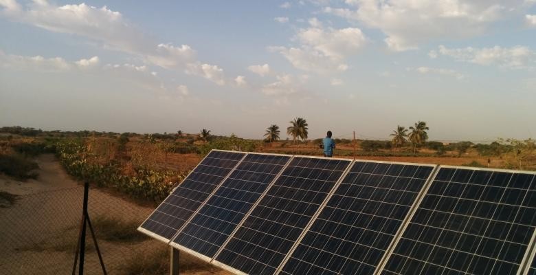 Five solar panels laid side-by-side on a platform soak up the sun