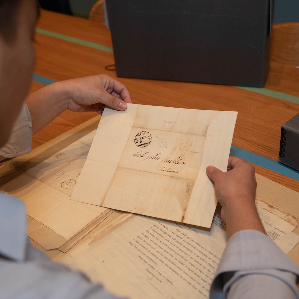 Man holding very old paper with writing on it