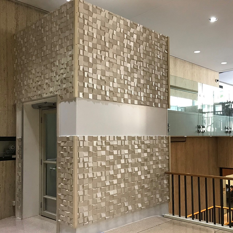 A lift enclosed with travertine walls and terrazzo floors to match the surrounding atrium in the International Affairs Building.
