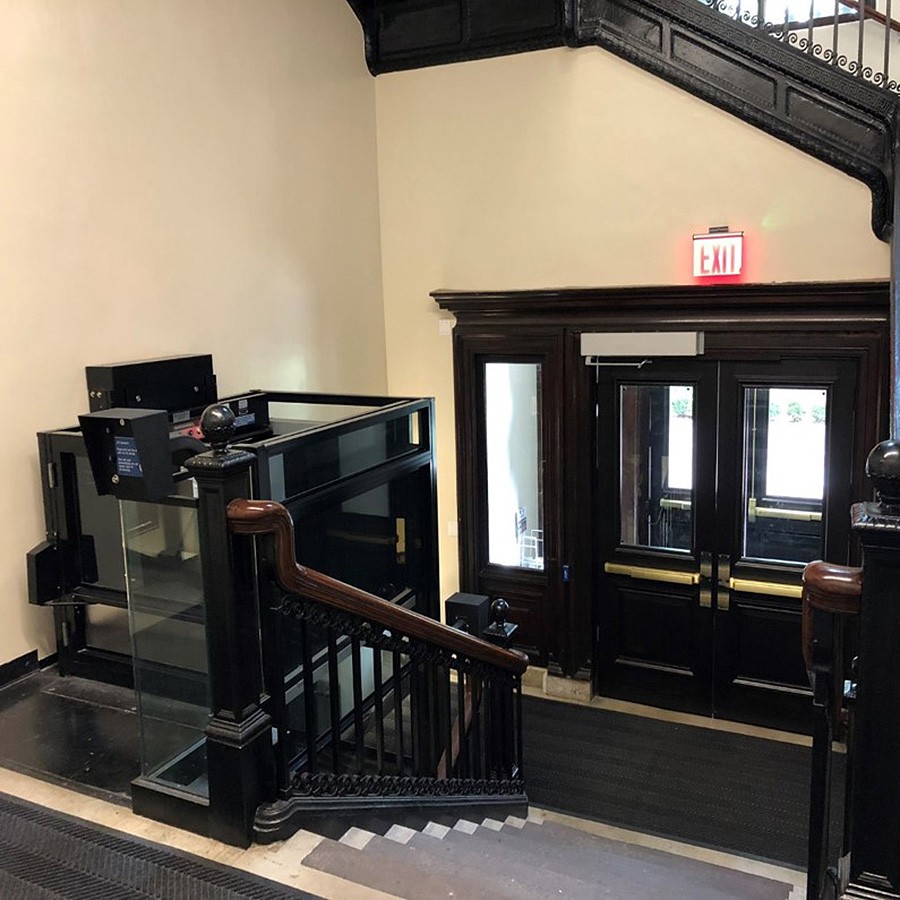 A lift sits at the top of a staircase in the Mathematics Building. 