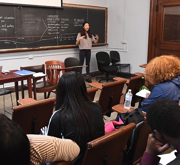 Noel Um, a graduate student at Teachers College, and her students take a deep dive into North America's indigenous people's history in her class, "Decolonizing US History." Um notes, "As an educator, I am constantly learning from my students as producers of knowledge. They're curious and thoughtful scholars that already are challenging dominant colonial narratives in their own lives." Young woman teaching a class