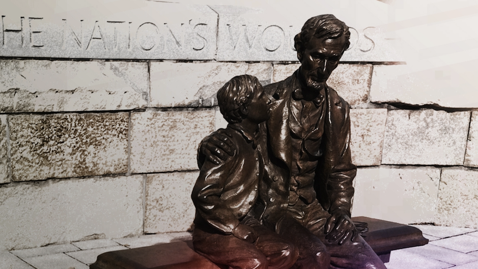 A statue of Abraham Lincoln and his son, Tad, in Richmond, VA commemorating his visit to the city near the end of the Civil War. Bronze statues of boy looking at father with sad expressions