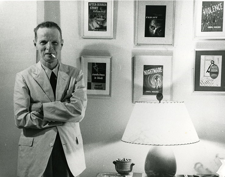 Cornell Woolrich in Hotel Franconia by a wall filled with his movie posters.