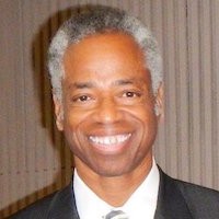 Headshot picture of an older man in a suit