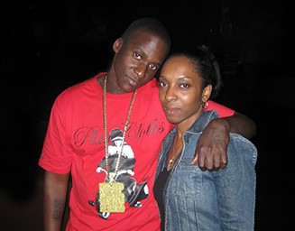 Gene 'Malice' Thornton in a gold chain and red T-shirt next to his tour manager, Regan McCoy, in a jean jacket. 