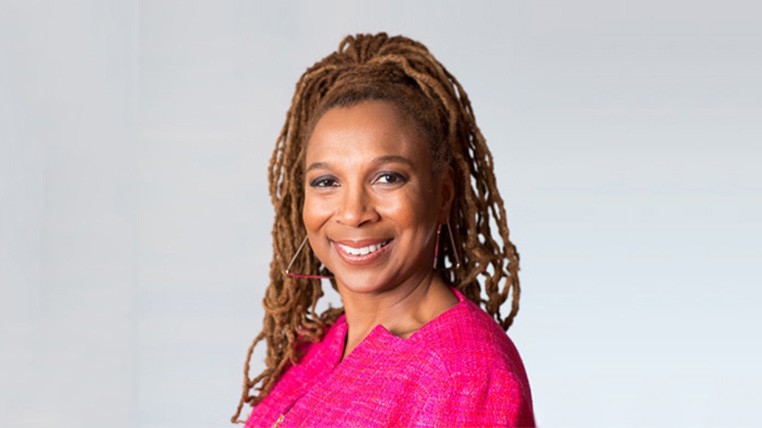 Kimberle Crenshaw in a pink blazer in front of a gray background