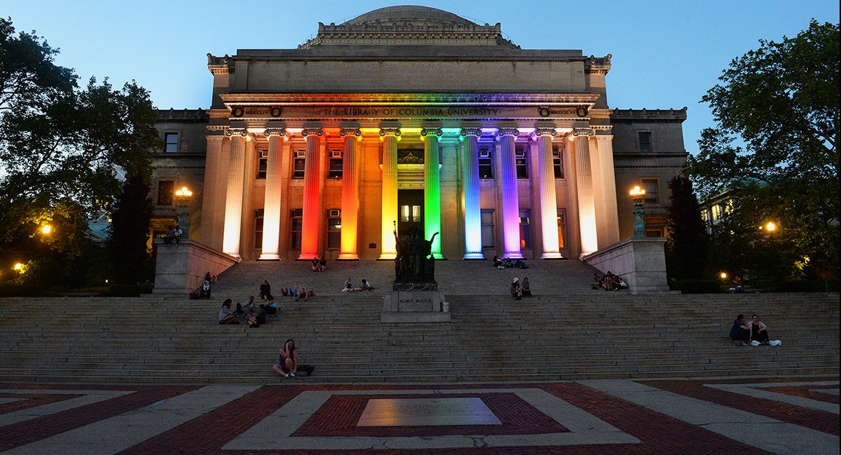 Low Library's Romanesque columns lit up in rainbow colors.