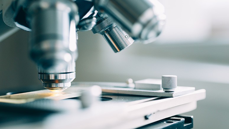 Close-up image of a silver metal microscope 