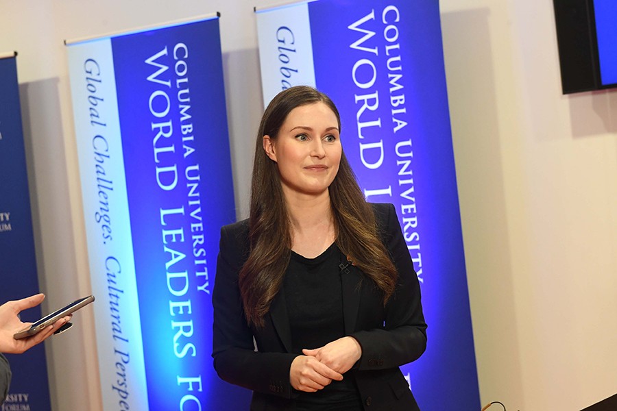 Sanna Marin, Prime Minister of Finland, poses against blue banners reading "Columbia University World Leaders Forum."