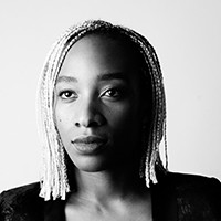 Headshot of Karimah Ashadu, a dark-skinned woman with light braids in a black top