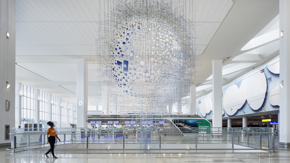 Sarah Sze, Shorter than the Day, 2020; powder coated aluminum and steel; commissioned by LaGuardia Gateway Partners with the Public Art Fund for LaGuardia Airport’s Terminal B; photo: Nicholas Knight. A circular sculpture hangs from the ceiling in an airport hall.