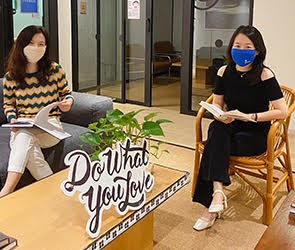 Two women sitting in a WeWork office waiting room in Shanghai, China