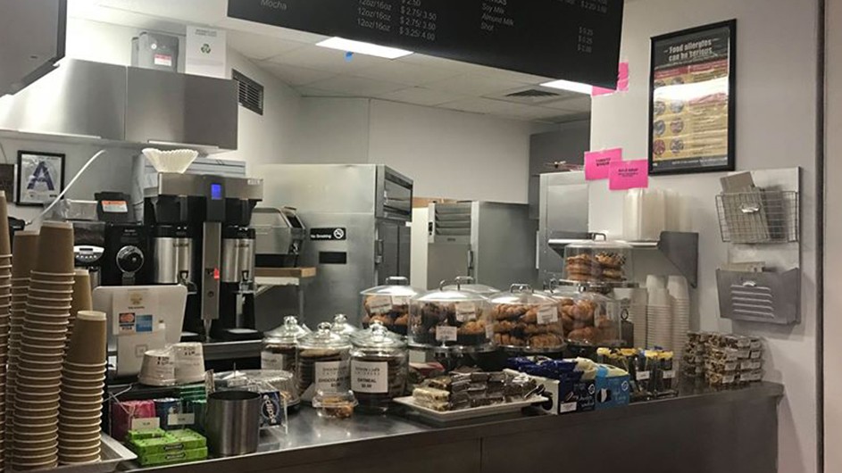 Brownie’s Cafe in Avery Hall: a stainless steel deli counter covered with jars of cookies and candy with hot coffee machines in the background.
