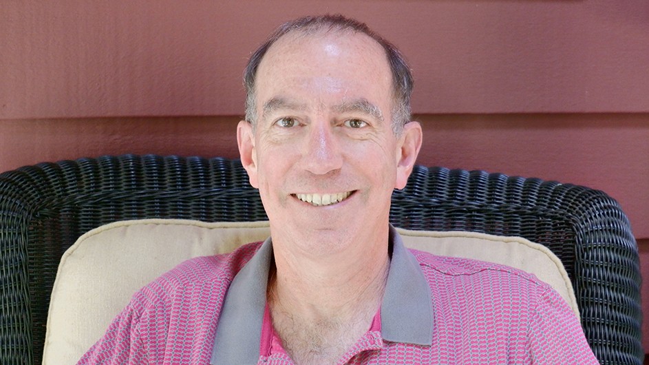 Professor David Klass is adapting his novel into a screenplay for Netflix. David Klass: a man smiles for the camera.