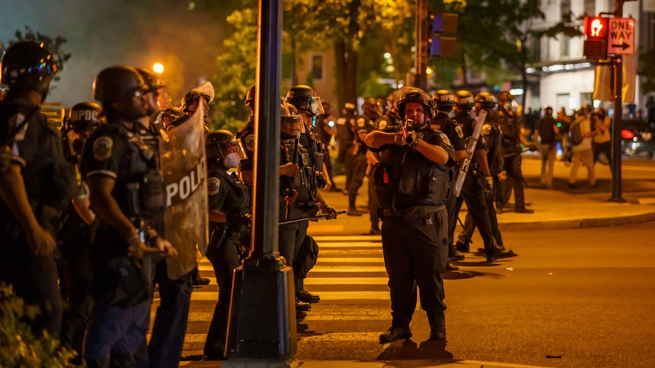 Police in riot gear near the White House on May 30, 2020. Photo credit: B. Grocker/Shutterstock Police in the streets of Washington, D.C., heavily armed with riot gear at night.