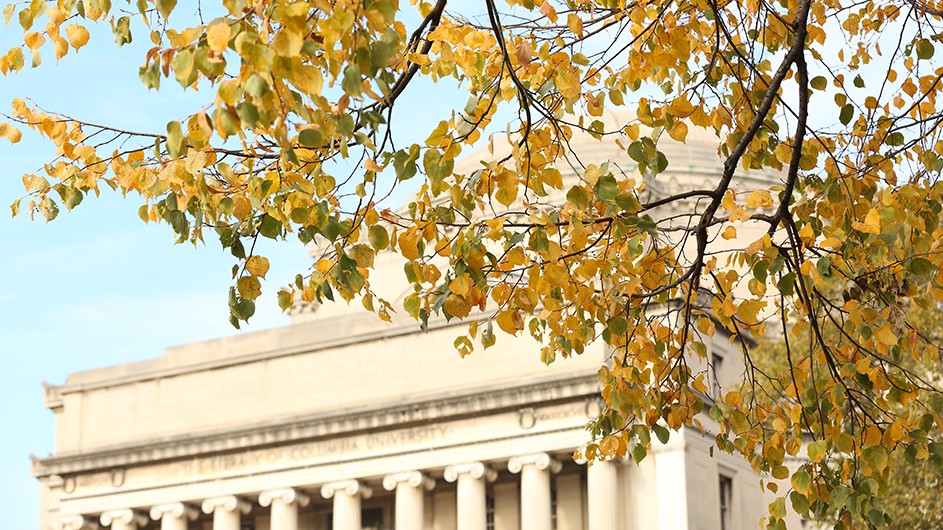 Fall foliage against the backdrop of Low Library, on a clear day.