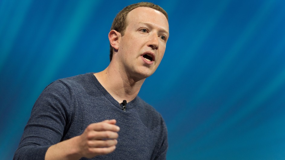 CEO of Facebook, Mark Zuckerberg A man with short reddish brown hair who is wearing a grey v-neck sweater and seems to be speaking.