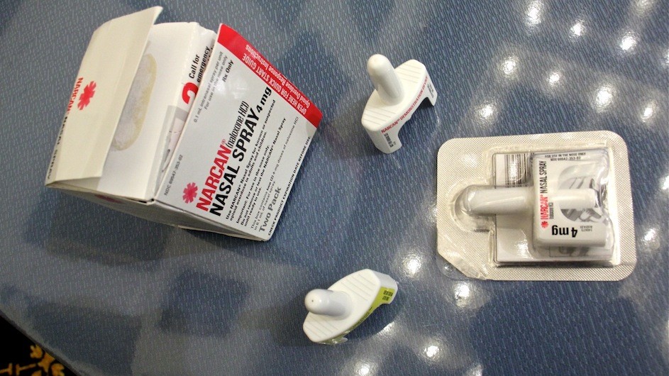 A box and several naloxone spray bottles