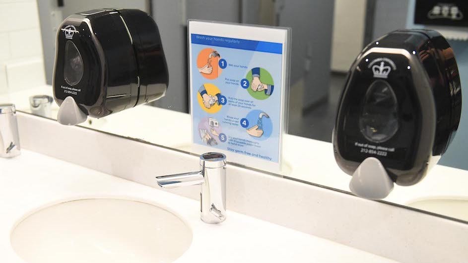 A sign encouraging hand washing in a bathroom on Columbia University's campus. Photo credit: Eileen Barroso Signage in a Columbia University bathroom asking people to wash their hands.