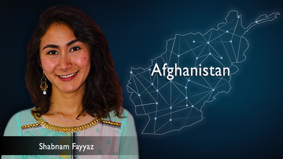 A woman with medium length dark hair in a blue and pink top, against a backdrop of a map of Afghanistan laid out in stars.