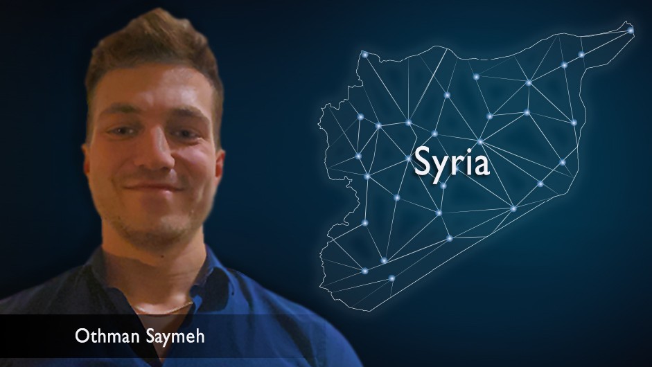 Headshot of a man with short brown hair, against the backdrop of a celestial map of Syria.