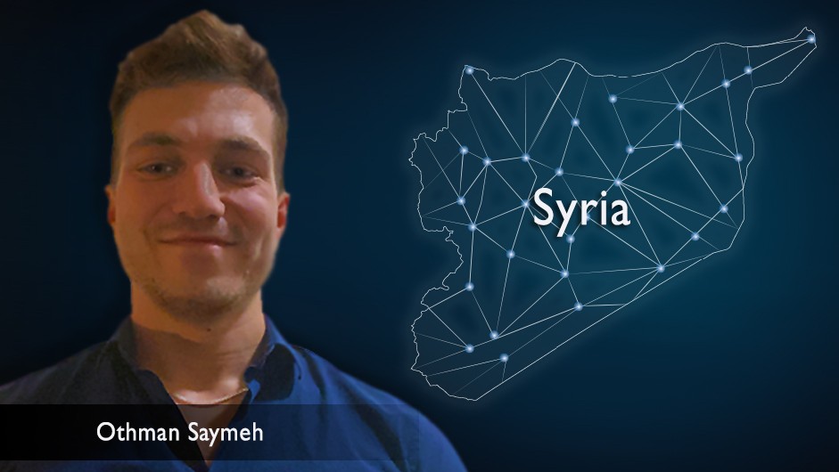 Headshot of a man with short brown hair, against the backdrop of a celestial map of Syria. 