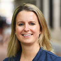 Headshot of a woman with blond hair in a blue top