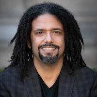 A head shot of a man with dark hair.