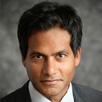 Jameel Jaffer: A headshot of a man with short dark hair and who is wearing a suit.