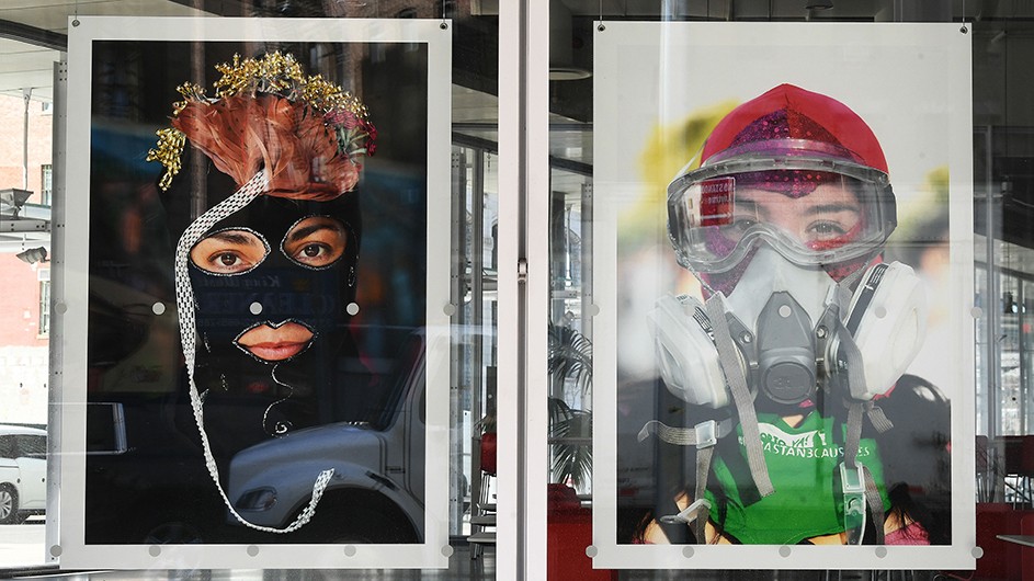 Large photos of women wearing elaborate masks