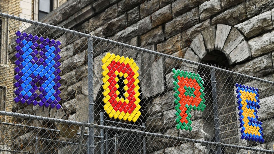 A photo of a fence with the word "HOPE" in colorful letters on it.