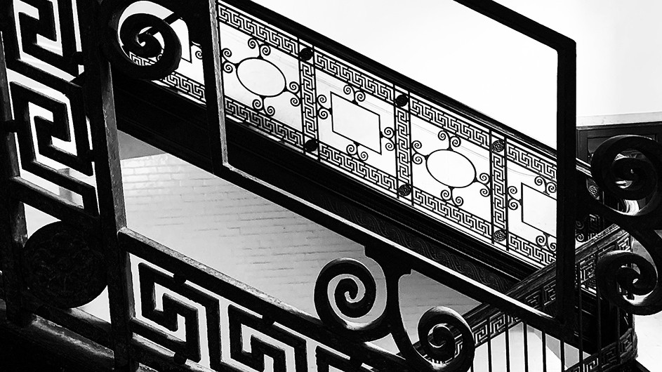 A black and white photo of a ornate iron work 