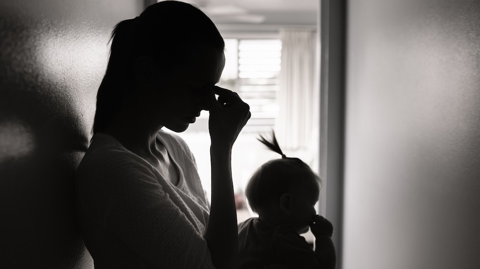 A black and white photo of a mother and baby in silhouette