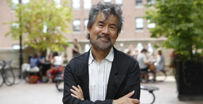 David Henry Hwang with his arms crossed, smiling.