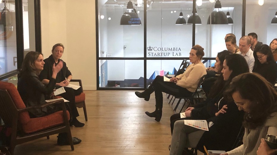UBS Vice Chairman Jolyne Caruso-Fitzgerald (far left) and SIPA Professor Sarah Holloway (second from left) discuss impact investing. Two women seated speaking to an audience