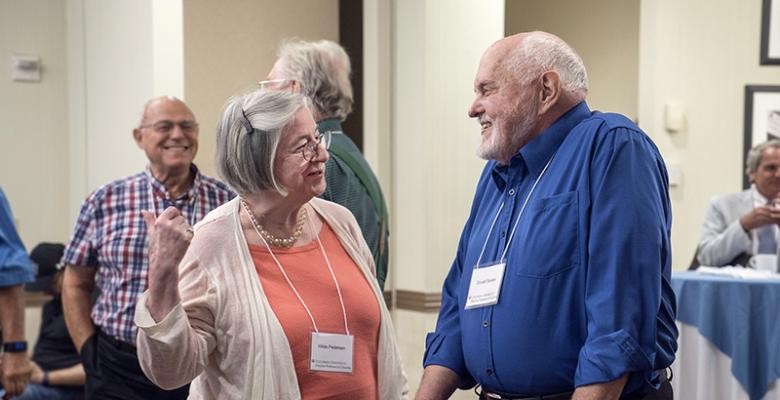 Photo by Barbara Alper two senior faculty members talking