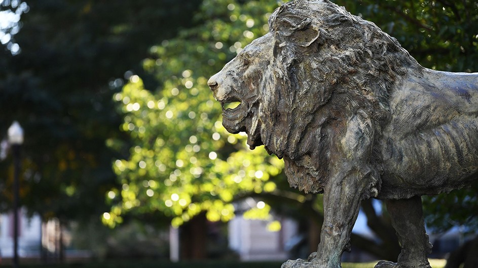 A lion statue on Columbia's leafy Morningside campus