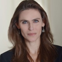 headshot of woman with long brown hair and blue jacket