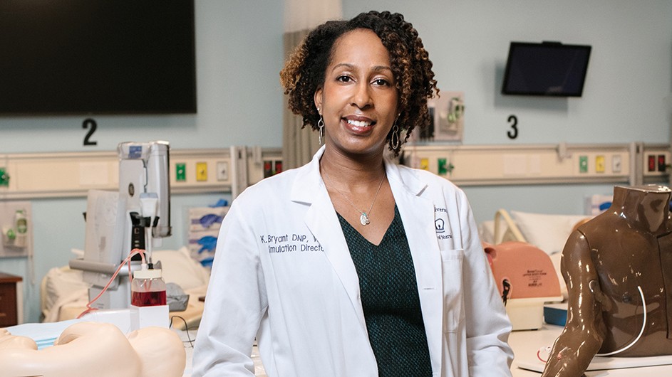 Black woman with dark curly hair in lab coat