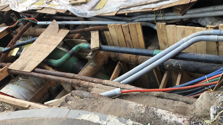 When the United States developed water supply systems, hundreds of millions of tons of lead pipes were allowed to crisscross the nation without government oversight. Photo: David Rosner brown boards in disarray with green, silver and red pipes intertwining