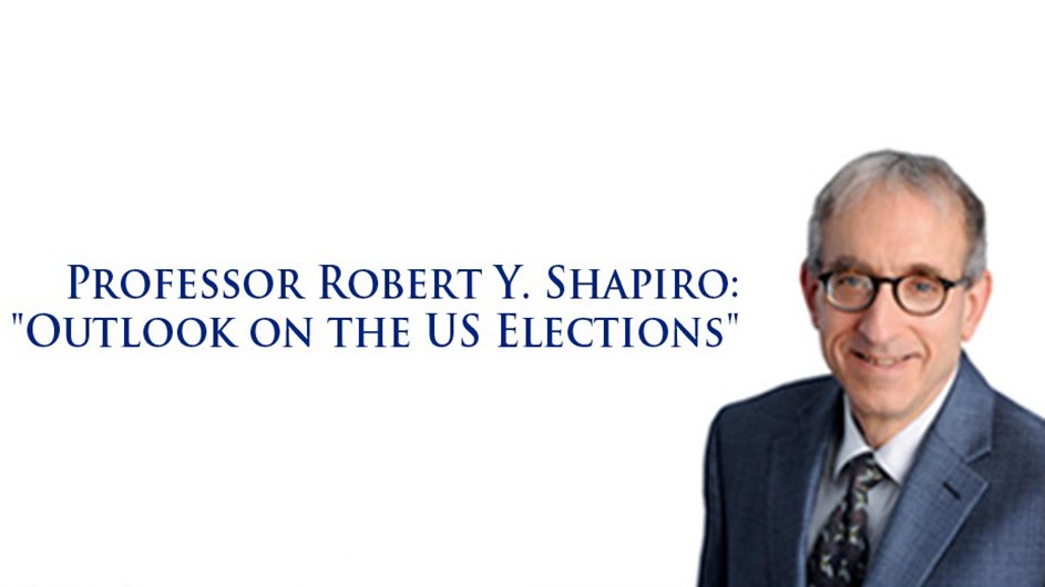 A bespectacled man smiling in front of white background