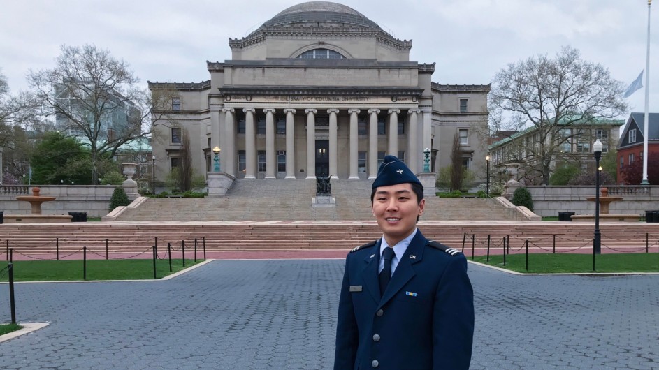 Asian man in military uniform in front of a domed building