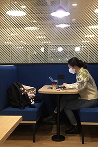 Subin Kim at WeWork in Seoul young Asian woman typing at a computer desk in brightly lit room