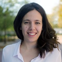 Ana Asenjo-Garcia: head shot of young woman with long brown hair and white shirt