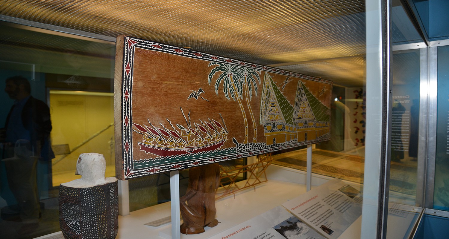 A wooden storyboard depicting warriers in a canoe from the Republic of Palau.
