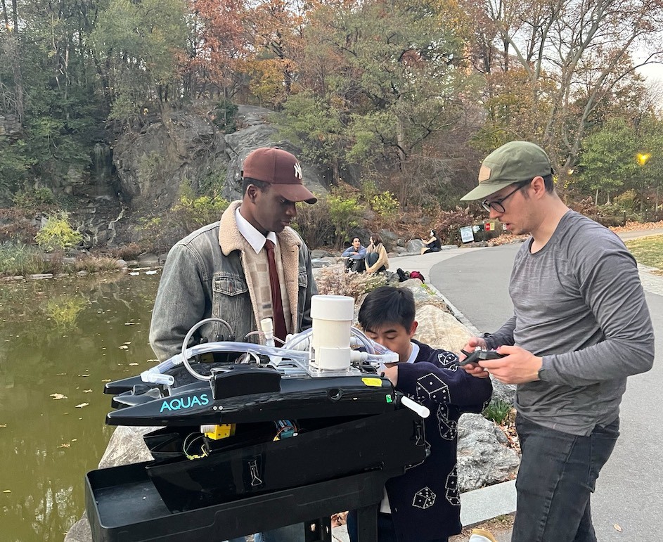 O'Ferrall and his teammates prepare the AQUAS boat for a test run in Morningside Pond. O'Ferrall and his teammates Sean Paul-Bonometre and Marcus Lam prepare the AQUAS boat for a test run in Morningside Pond. (Credit: Minju O’Rourke)